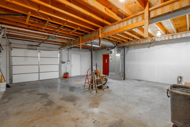 garage featuring heating unit and a garage door opener