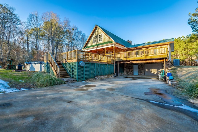 view of side of home featuring a garage and a deck