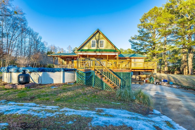 back of house featuring a covered pool