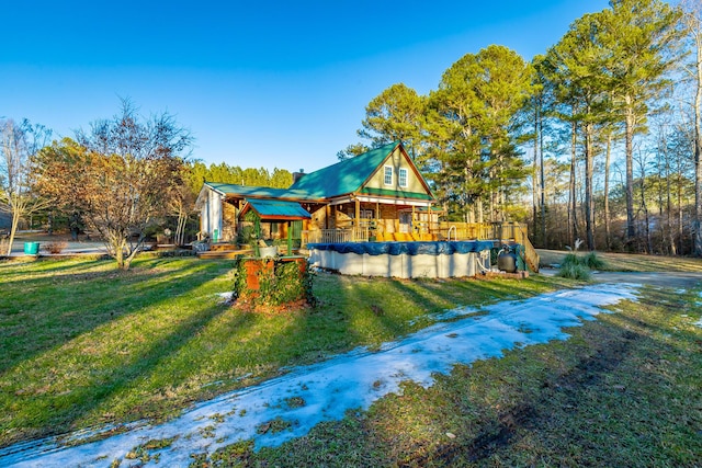 exterior space with a lawn and a covered pool