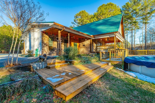 wooden terrace with a covered pool and ceiling fan