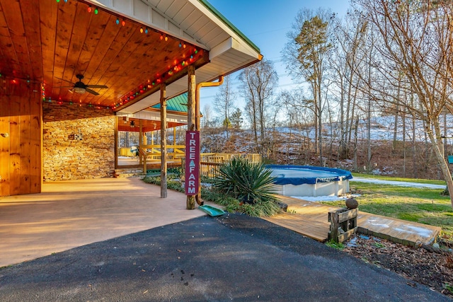 view of patio / terrace with a covered pool and ceiling fan