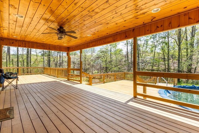 unfurnished sunroom with ceiling fan