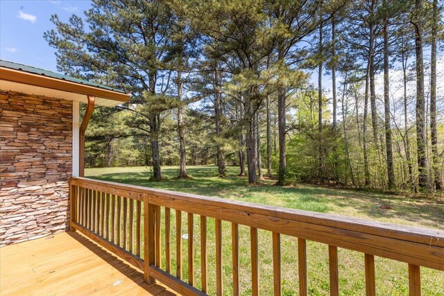 wooden deck featuring a yard