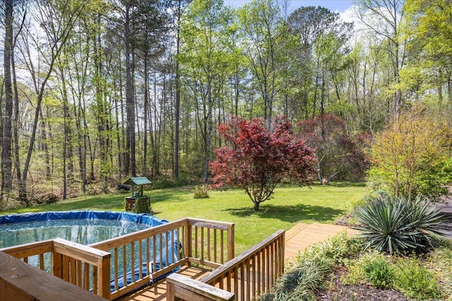 exterior space with an outdoor pool and a lawn