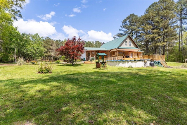back of house featuring an outdoor pool and a lawn