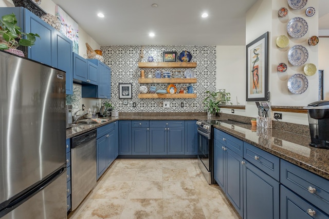 kitchen featuring stainless steel appliances, dark stone countertops, decorative backsplash, and blue cabinetry