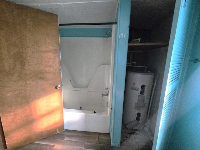 bathroom featuring a tub to relax in, water heater, and wood-type flooring