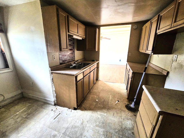 kitchen featuring decorative backsplash and sink