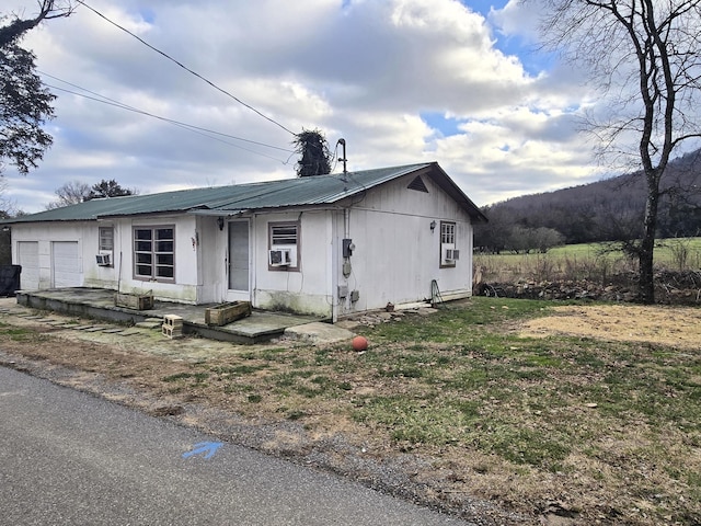 view of front of house featuring cooling unit and a garage