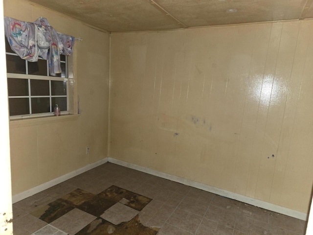 spare room featuring wood walls