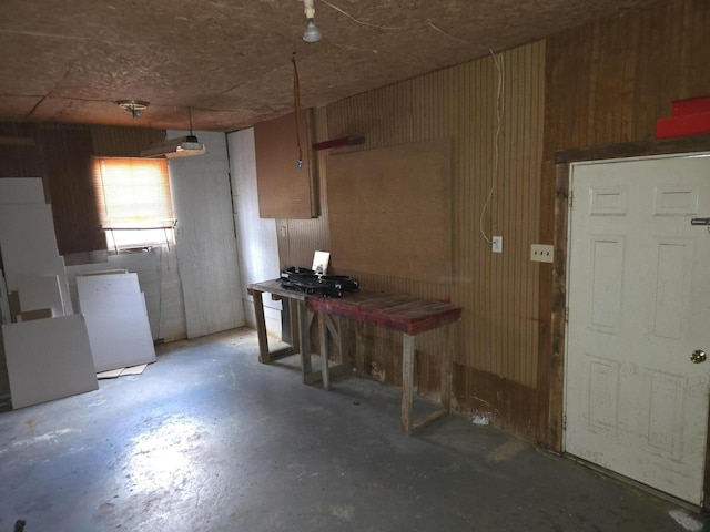 kitchen with wooden walls and concrete floors