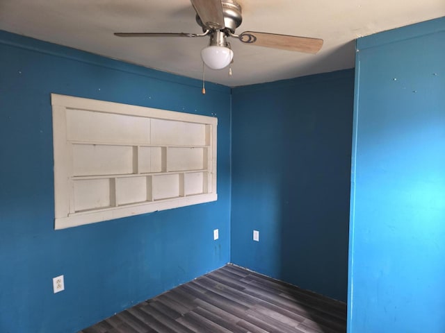 empty room featuring dark hardwood / wood-style floors, built in features, and ceiling fan