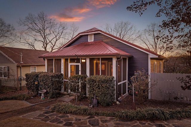 view of front of house featuring a sunroom