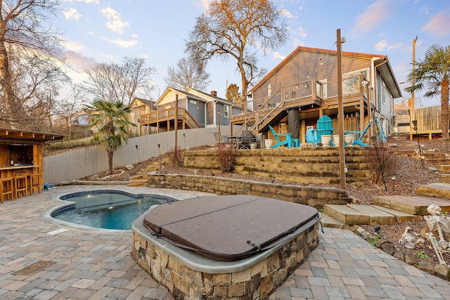 view of pool featuring a patio area, a hot tub, and a deck