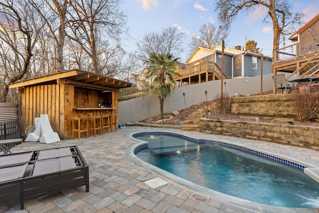 view of pool with exterior bar and a patio