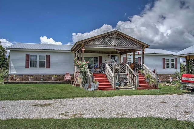 view of front of property with covered porch and a front yard