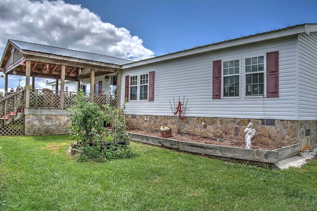 view of side of home featuring a yard