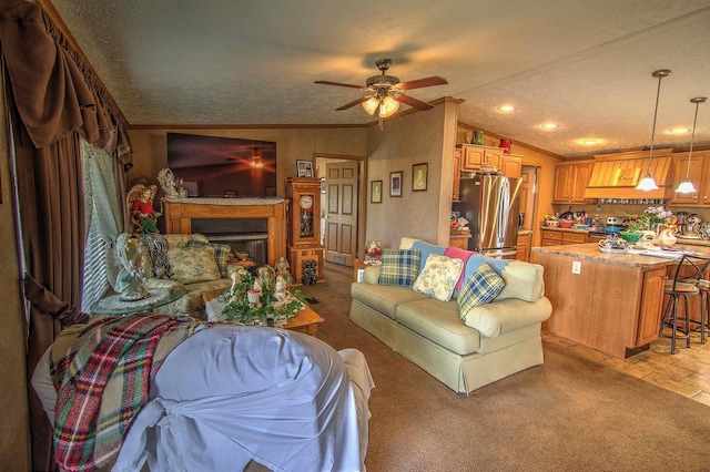 carpeted living room with ceiling fan, lofted ceiling, a textured ceiling, and ornamental molding