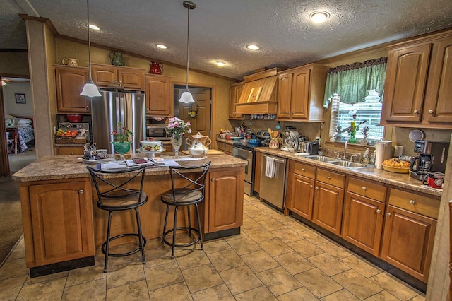 kitchen featuring custom exhaust hood, stainless steel appliances, vaulted ceiling, sink, and a kitchen island