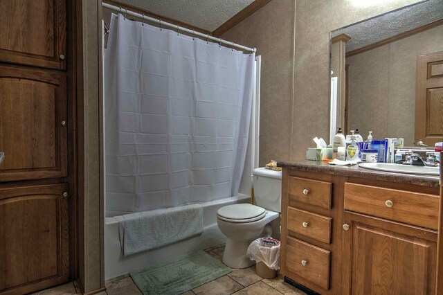 full bathroom with tile patterned floors, a textured ceiling, toilet, shower / bath combo with shower curtain, and vanity