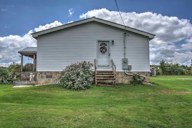 back of property featuring a lawn