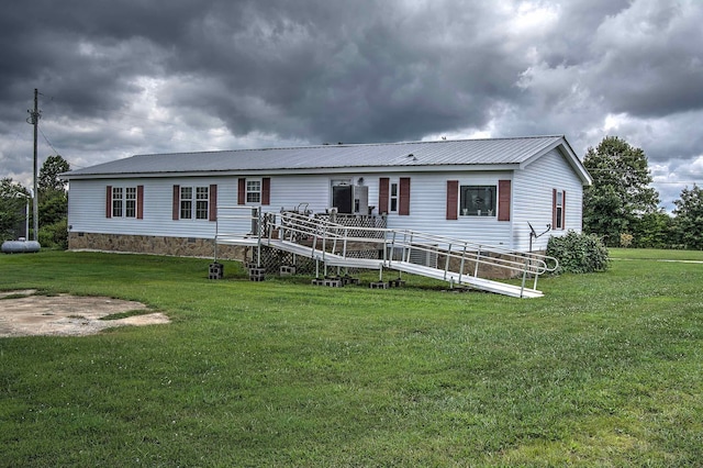 back of house with a yard and a deck