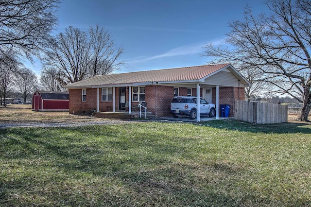 ranch-style house with a storage shed and a front yard