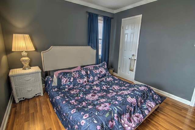 bedroom featuring crown molding and hardwood / wood-style flooring