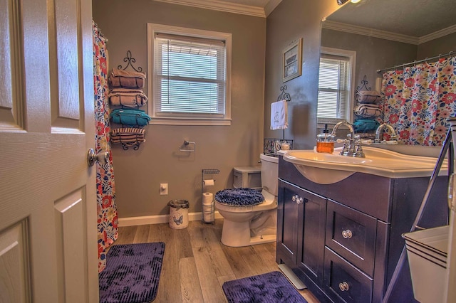 bathroom with toilet, vanity, ornamental molding, and hardwood / wood-style floors