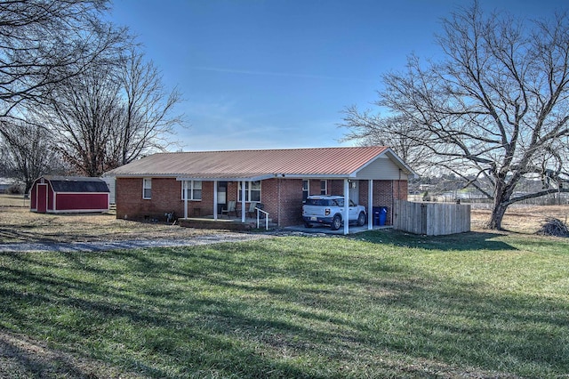 view of front of property featuring a front yard and a storage shed