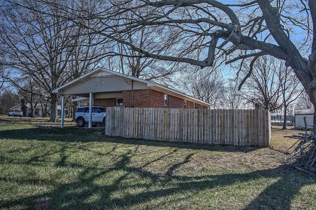 exterior space with a carport and a yard