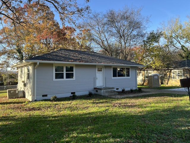 view of front of home featuring cooling unit and a front lawn