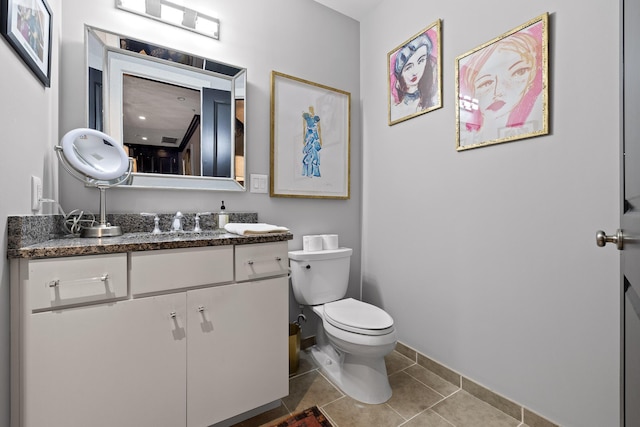 bathroom featuring tile patterned floors, vanity, and toilet