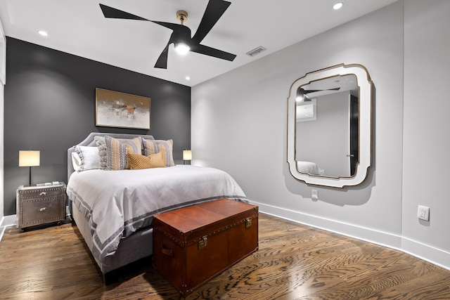 bedroom with dark hardwood / wood-style floors and ceiling fan