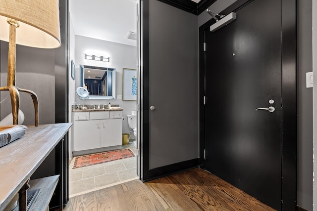 bathroom with hardwood / wood-style floors, vanity, and toilet