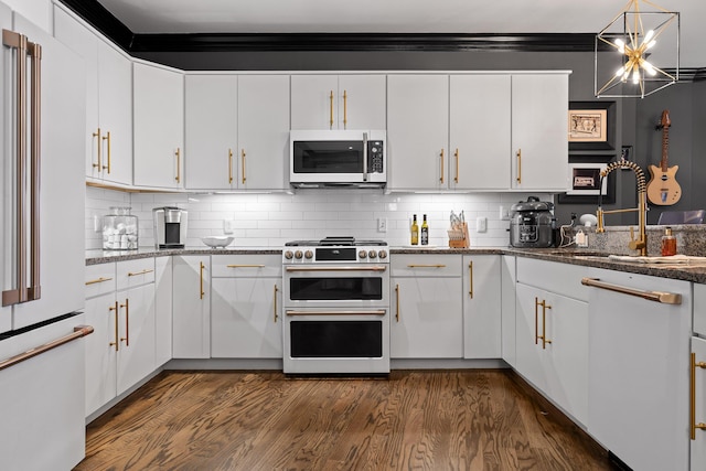 kitchen featuring tasteful backsplash, white cabinetry, and high end appliances