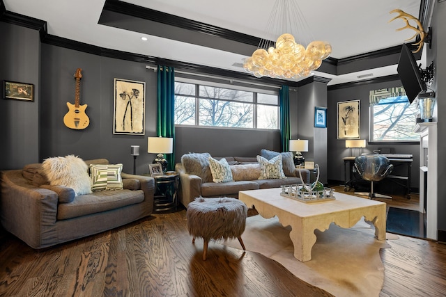 sitting room with plenty of natural light, wood-type flooring, a notable chandelier, and ornamental molding