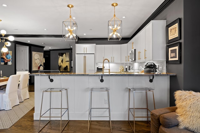 kitchen with backsplash, white cabinets, high end white fridge, dark stone countertops, and dark hardwood / wood-style flooring