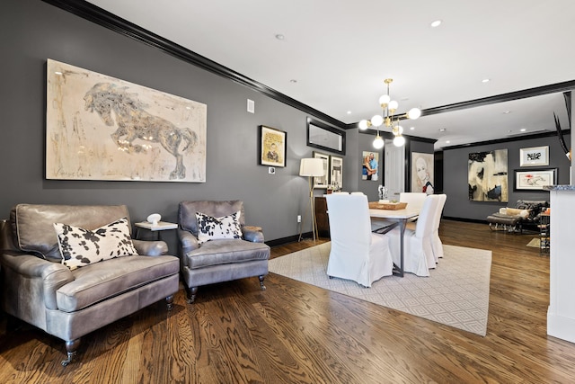 dining room with hardwood / wood-style floors, an inviting chandelier, and ornamental molding