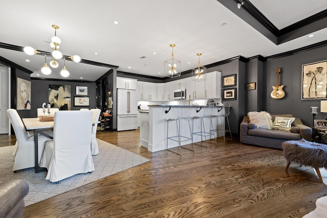 dining space with dark hardwood / wood-style floors, crown molding, and a notable chandelier