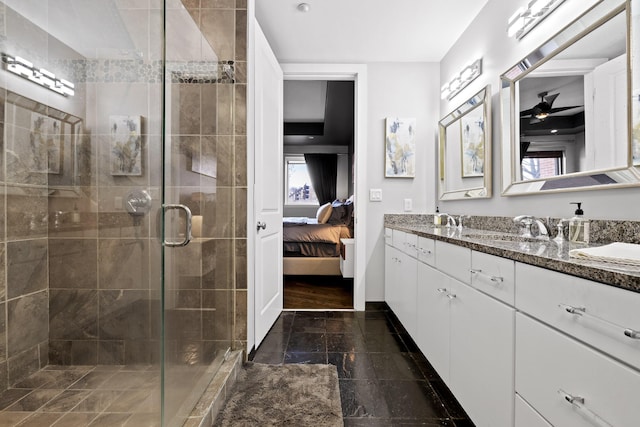 bathroom featuring a shower with door and vanity