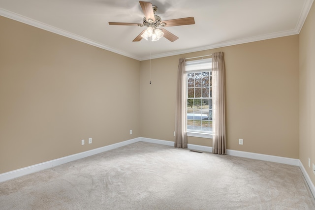 carpeted empty room with ceiling fan and ornamental molding