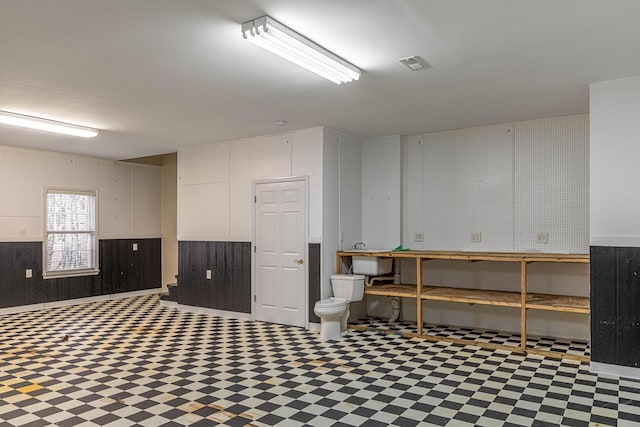 basement featuring wood walls