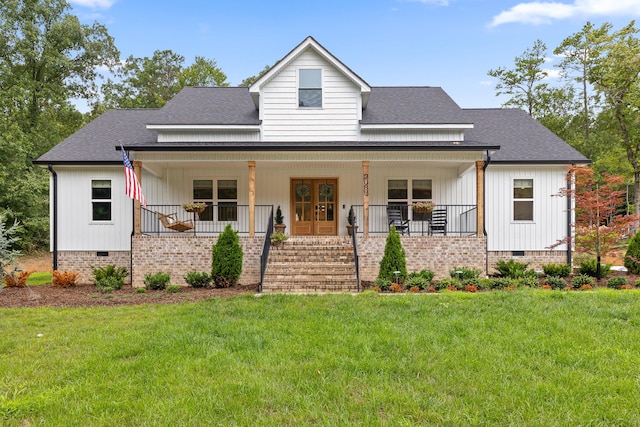 modern farmhouse style home featuring a porch, a front yard, and french doors