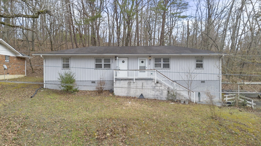 rear view of property with a yard