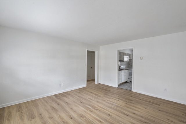 spare room with light wood-type flooring