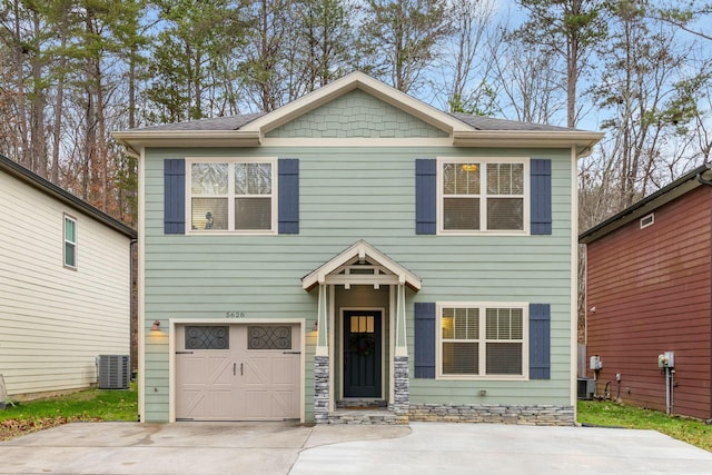 craftsman-style home featuring a garage and central air condition unit