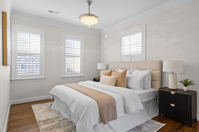 bedroom with dark hardwood / wood-style flooring and crown molding