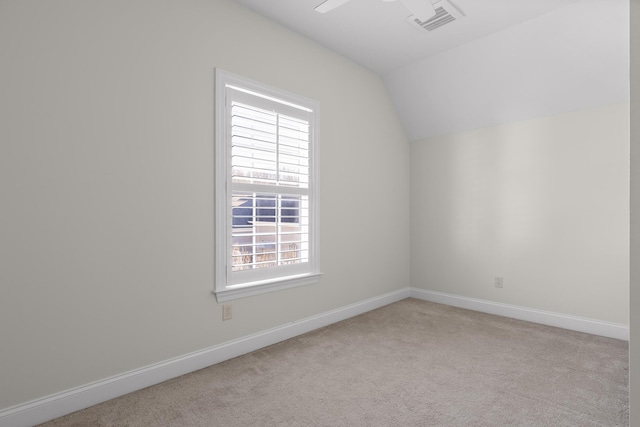 additional living space featuring lofted ceiling and light colored carpet